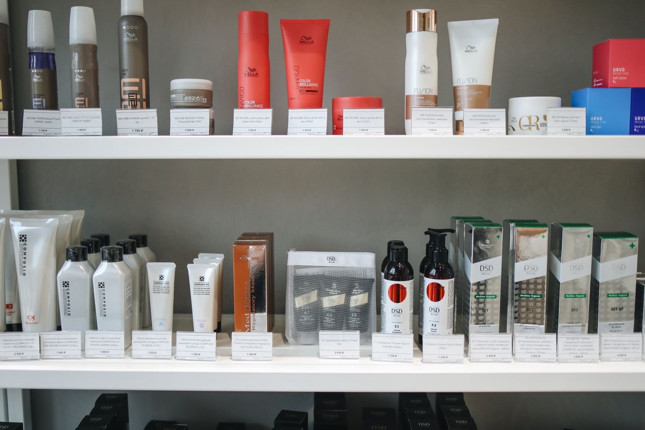 Home Assorted skincare and beauty products neatly displayed on shelves in a store setting.
